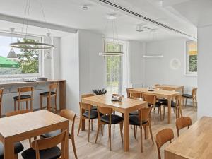 a dining room with wooden tables and chairs at Wellness Apartmány Pastviny in Pastviny