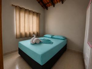 a bedroom with a bed with a swan on it at Canto Sereno Refúgio entre Praias e Ilhas in Paraty