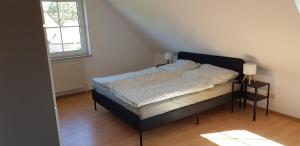a bedroom with a bed and two night stands at Fewo Mandelsloh in Neustadt am Rübenberge