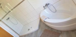 a bathroom with a toilet and a glass shower at Fewo Mandelsloh in Neustadt am Rübenberge +3 photos