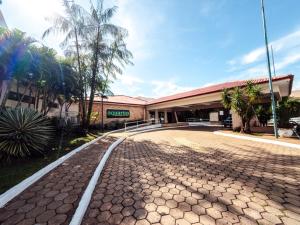 a building with a road in front of it at Rede Andrade Aquarius in Porto Velho