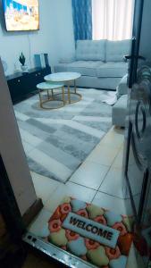 a view of a living room with a welcome sign on the floor at Kerry Luxury Stays in Athi River