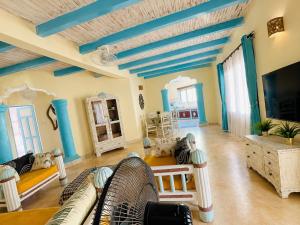 a living room with couches and a tv at Tropical Court 2 BedroomDiani Beach villa in Kwale