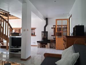 a living room with a couch and a tv at L'Entre Monts in Saint-Pierre-dʼEntremont