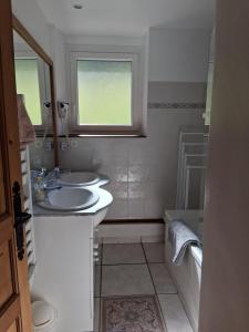 a white bathroom with two sinks and a window at L'Entre Monts in Saint-Pierre-dʼEntremont +29 photos
