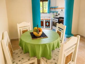 a kitchen with a table with a bowl of fruit on it at Tropical Court 2 BedroomDiani Beach villa in Kwale