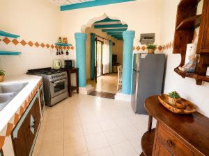 a kitchen with a sink and a stove at Tropical Court 2 BedroomDiani Beach villa in Kwale +20 photos