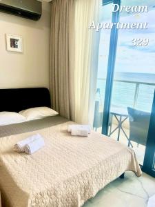 a bedroom with a bed with two towels on it at Bamboo beach in Ts'ikhisdziri +17 photos