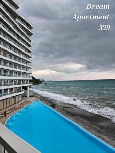a view of the ocean from the balcony of a building at Bamboo beach in Ts'ikhisdziri