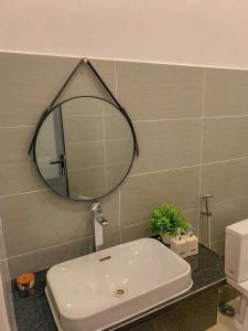 a bathroom with a sink and a mirror on the wall at Nhi Homestay Phòng đơn 1 in Rạch Giá