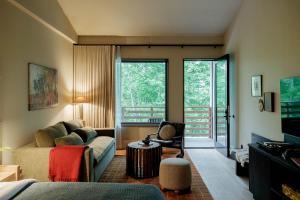 a living room with a couch and a chair at New Paltz Way Hotel in New Paltz
