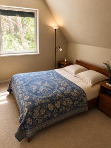 a bedroom with a large bed and a window at Žalioji vila in Varteliai +21 photos
