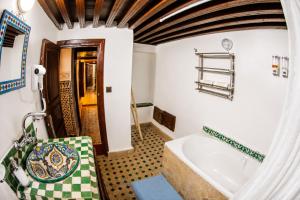 a bathroom with a tub and a sink at Riad Nassim Fez in Fez