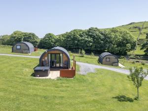 a group of three domes in a grassy field at Willow in Ulverston