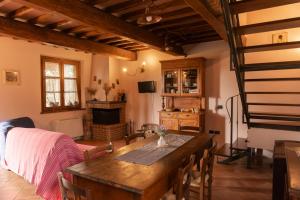 a living room with a table and a fireplace at Poggio Mille in Castiglione del Lago