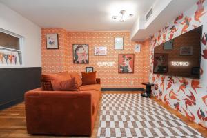 a living room with a couch and orange walls at Lamartine Chelsea in New York