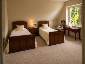 a bedroom with two beds and a window at Žalioji vila in Varteliai