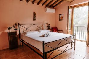 a bedroom with a bed and a large window at Poggio Mille in Castiglione del Lago +10 photos