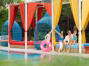a group of children are playing in a pool at Mercure Bangkok Sukhumvit 11 in Bangkok