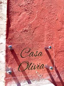 a red wall with the words cosa divina on it at Casa Olivia Bardolino - Garda Lake in Bardolino