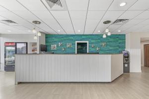 an office lobby with a reception desk and a green wall at Best Western Plus Ocean City in Ocean City +31 photos