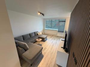 a living room with a couch and a tv at Vesturgata 8 KEF in Keflavík