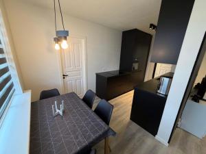 a dining room with a table and chairs and a kitchen at Vesturgata 8 KEF in Keflavík