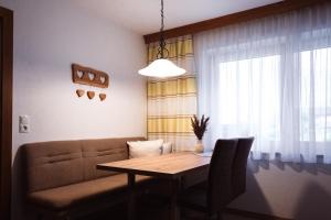 a living room with a table and a couch at Ferienwohnung Kreidl in Schlitters