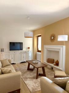 a living room with a table and a fireplace at Casa Olivia Bardolino - Garda Lake in Bardolino