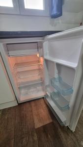 an empty refrigerator with its door open in a room at hostal olozaga in Alicante +28 photos