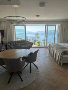 a bedroom with a bed and a table and chairs at Apartments Villa Manda in Novi Vinodolski