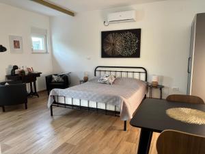 a bedroom with a bed and a table in it at Apartmani Stellar in Malinska