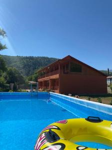 a large swimming pool in front of a house at Hotel Mirioni in Oni