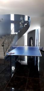 a blue table in a room with a spiral staircase at Near Yerevan Serlinhouse in Oshakan