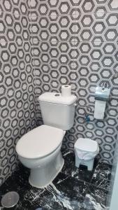 a bathroom with a white toilet and a wall at Pension Susita in Alicante +29 photos
