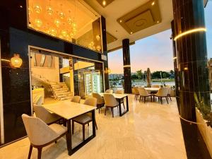 a restaurant with tables and chairs and a large window at Palace rif zicht in Nador
