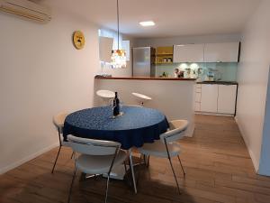a kitchen and dining room with a table and chairs at Garden apartment Vanya in Split
