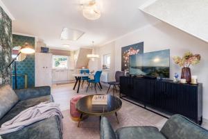 a living room with a couch and a flat screen tv at Ferienwohnung Rosen am Meer in Sassnitz