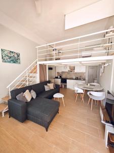 a living room with a couch and a dining room at Loft Suites - by Avelink in Spata