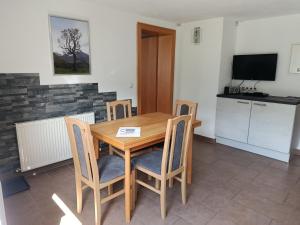 a dining room with a wooden table and chairs at Gästehaus Michael in Navis +15 photos