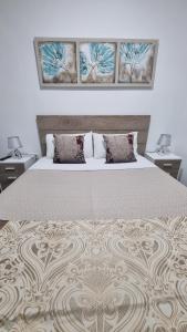 a bedroom with a large bed with two night stands at Pension Susita in Alicante