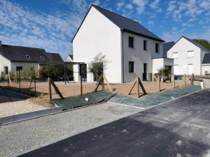 an empty playground in front of a house at Maison spacieuse - Perros Guirec in Perros-Guirec