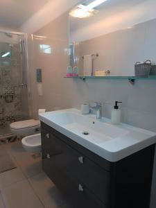 a bathroom with a sink and a toilet at Garden apartment Vanya in Split +24 photos