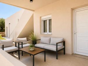 a patio with two chairs and a table at Musses apartment 1 Modern Studio with Free Parking in Limín Khersonísou