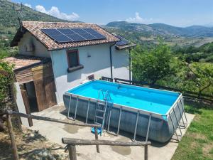 a house with a swimming pool with solar panels on the roof at Il Rifugio Rosa in Anagni