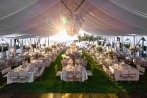 a wedding reception with tables and chairs under a tent at Grand Velas Riviera Nayarit-All Inclusive in Nuevo Vallarta +55 photos