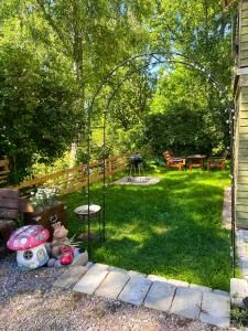 a garden with a gazebo and a grill in a yard at Daisy's Home Vimmerby in Vimmerby