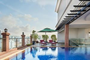 a swimming pool on the roof of a building at Queen Mansion Hotel & Stays in Phnom Penh