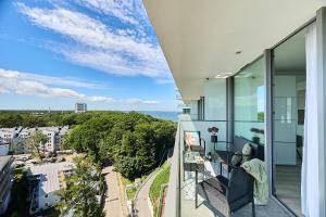 a balcony with a view of the ocean at WAVE Resort & Spa in Międzyzdroje