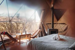 a room with a bed and a large window at Domos Uspallata in Uspallata +162 photos